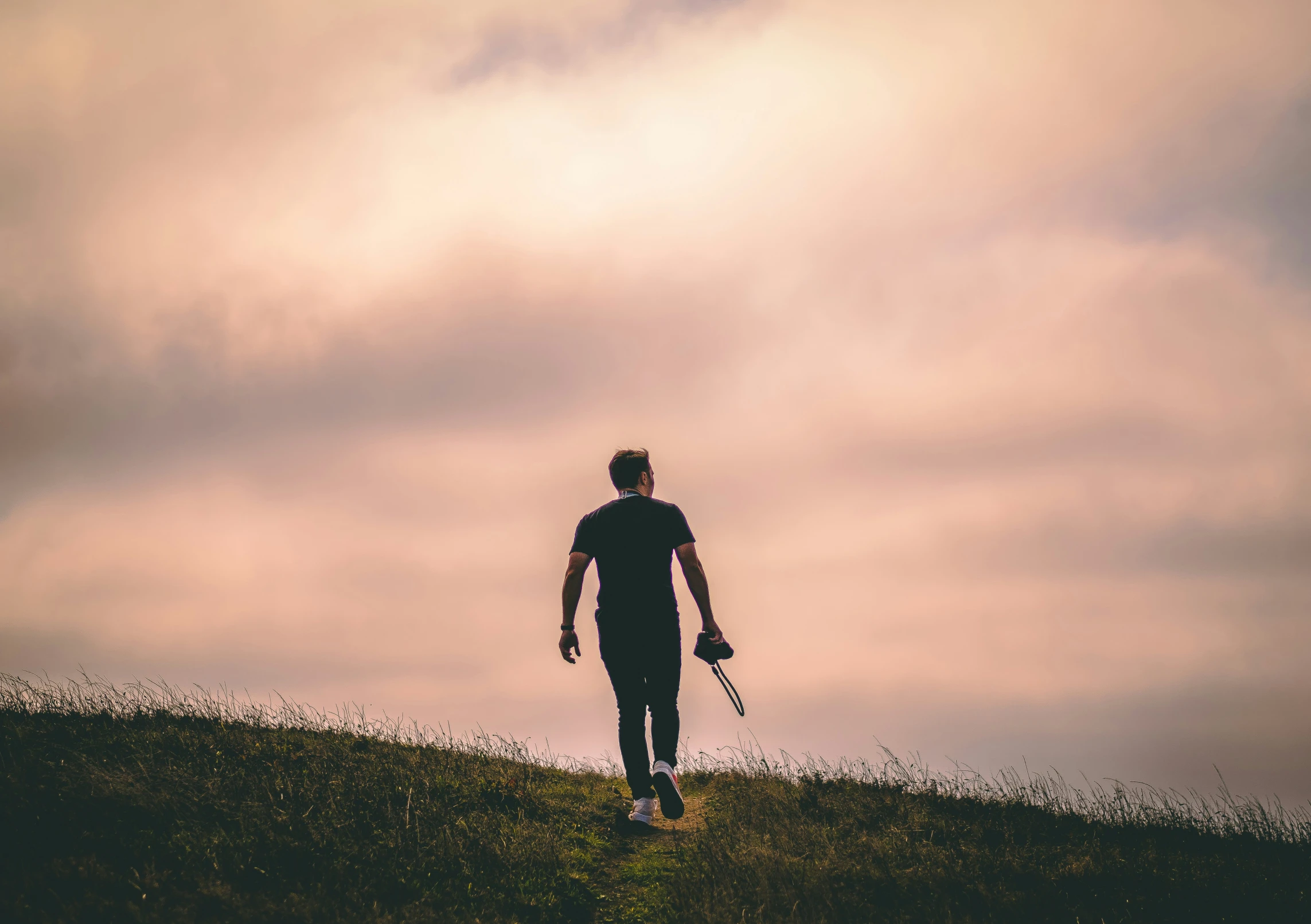 a man stands on the hill with his skis