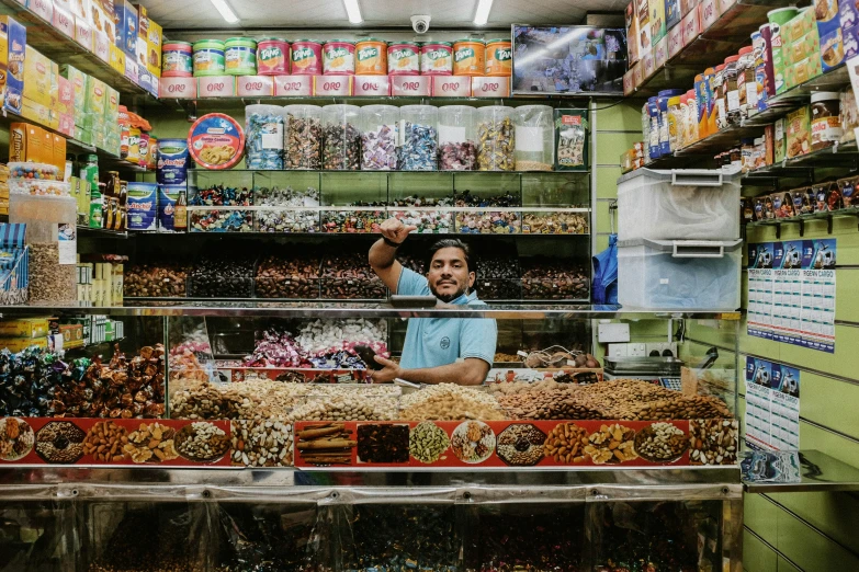 a man that is standing in a store near food