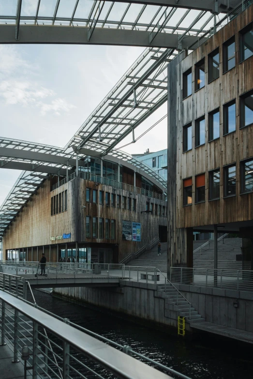 a building sitting next to a bridge under a cloudy sky