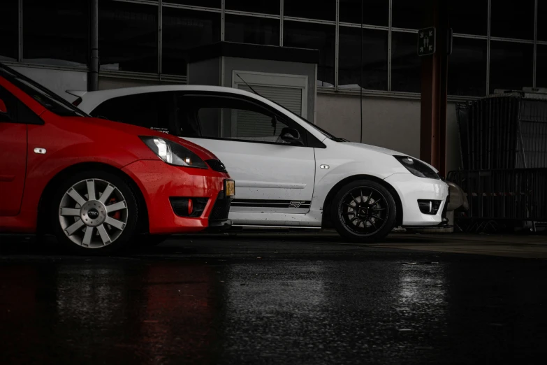 two smart cars are seen sitting side by side