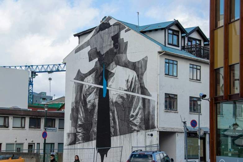 street art of a man holding a cross above the head