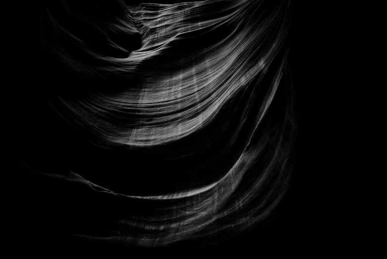 the black background of a large, white - striped wave