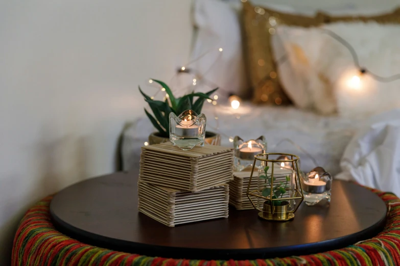 a nightstand with small glass containers holding candles