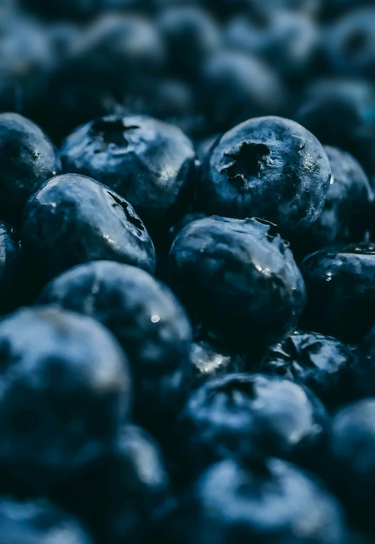 the blueberries are piled up close together