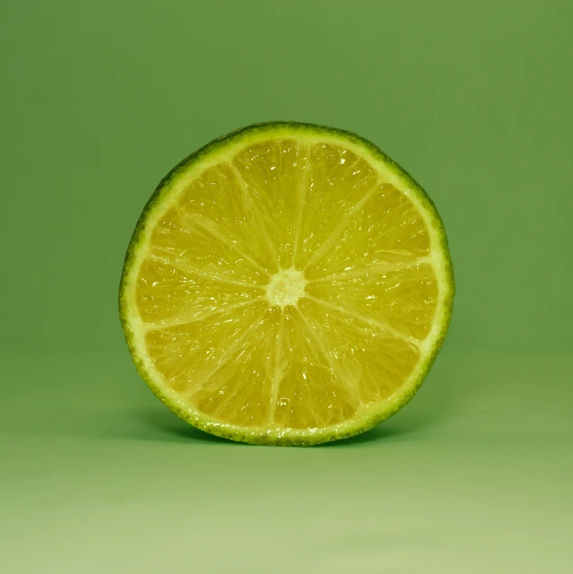 a sliced lime with a green background