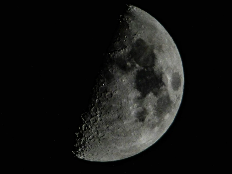 the moon, seen from a distance, showing its side