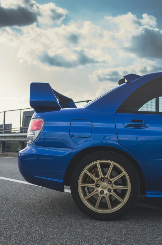 blue sedan with black ke pads in parking lot