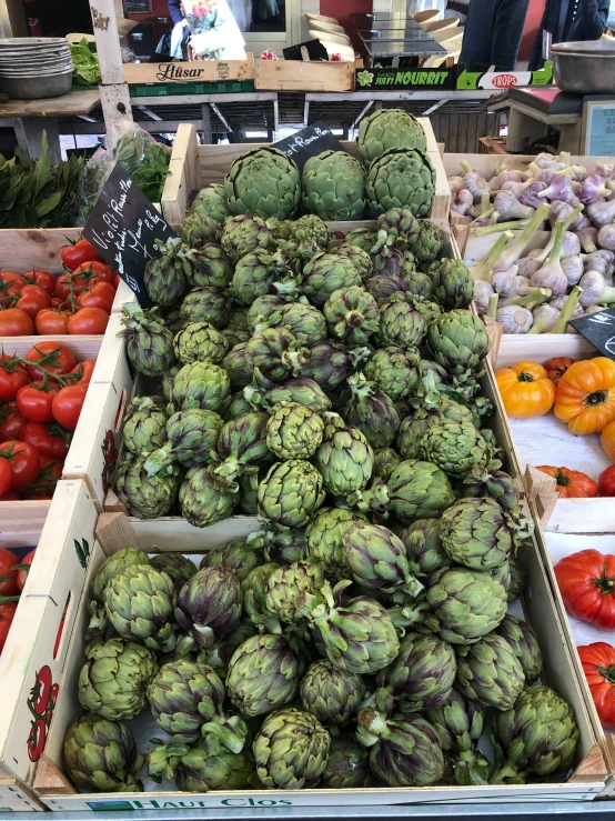 produce being displayed in an outdoor market with produce