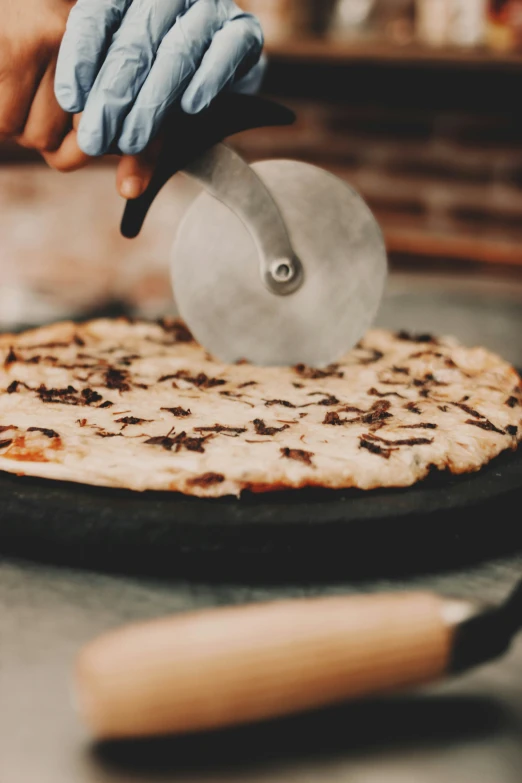 person  a piece of food on a pan