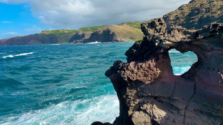 there is a view of water through the rocks