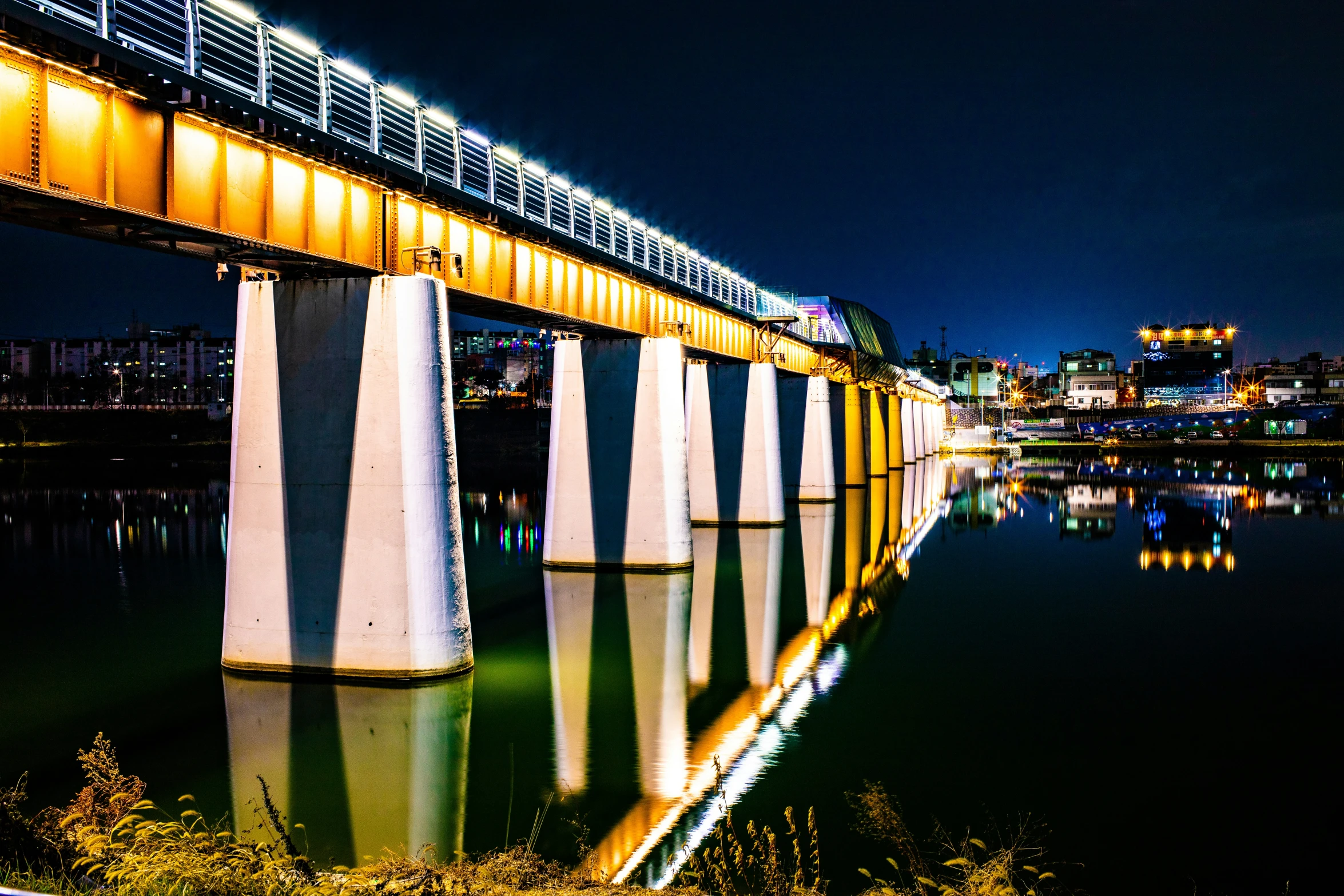 bridge and water at night with lights on