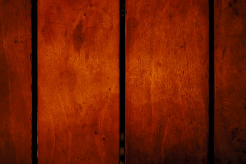 a wooden wall with a red clock on the top