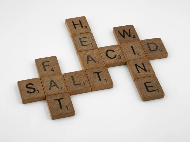 scrabbled wooden letter tile spelling the word faith, health, and salvation