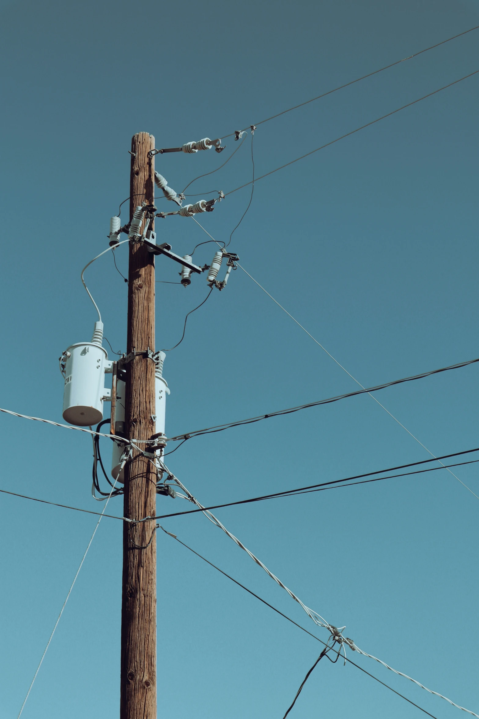 an old telephone pole with power lines