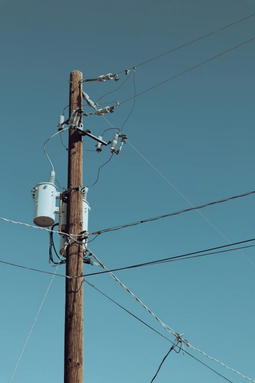 an old telephone pole with power lines