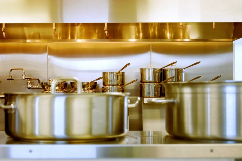 rows of pots and pans are lined up on the counter