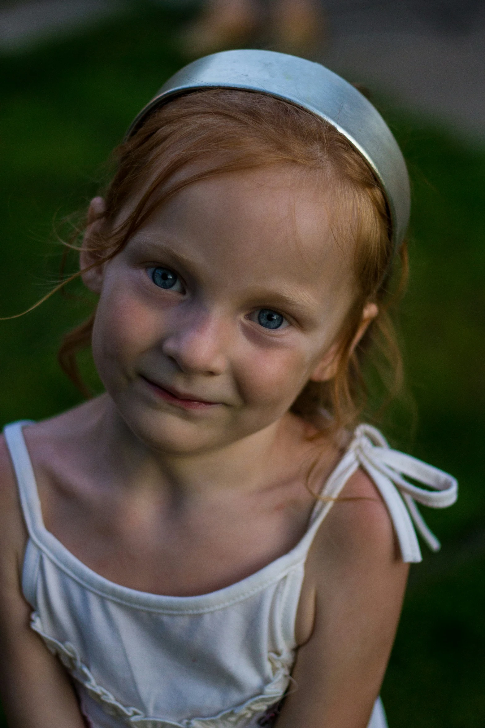 a girl in a white dress and a silver hat