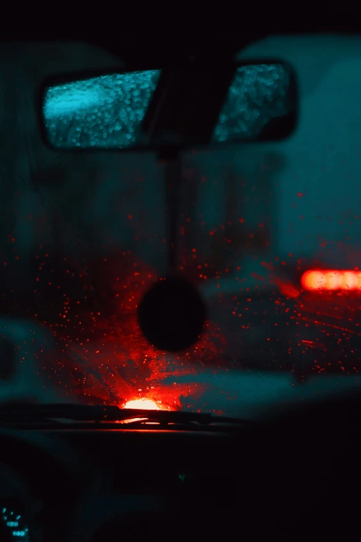 a view through the windshield of a vehicle at night