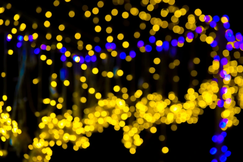 boke of christmas lights hanging above a city street