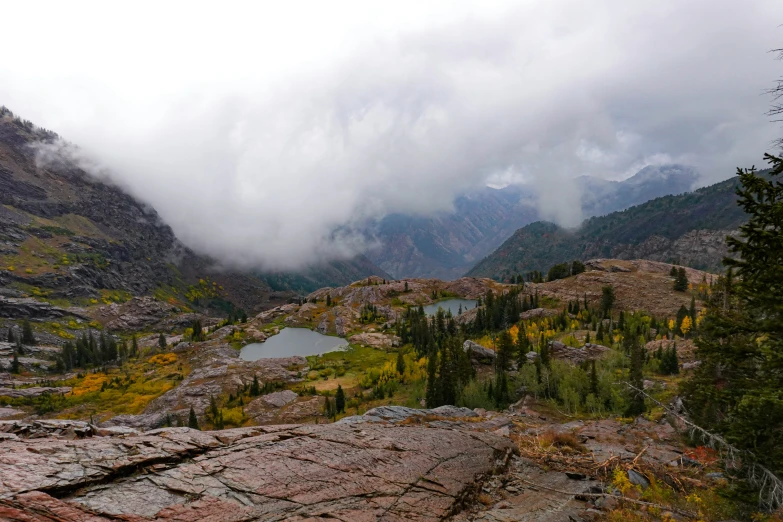 the view from a mountain top of a lake below