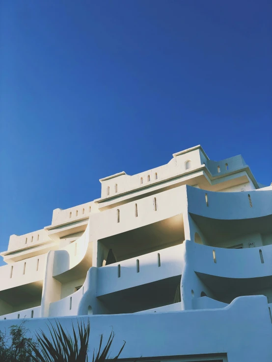 white buildings on the ocean with blue sky behind them