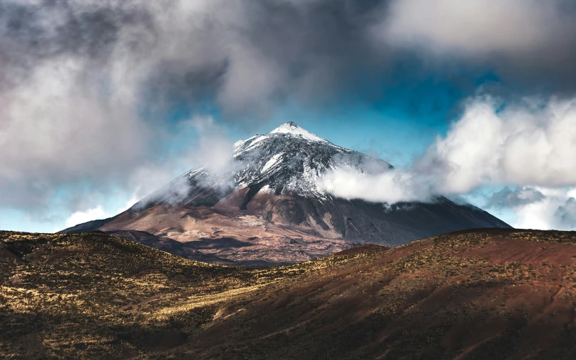 a huge mountain that has a snow capped top