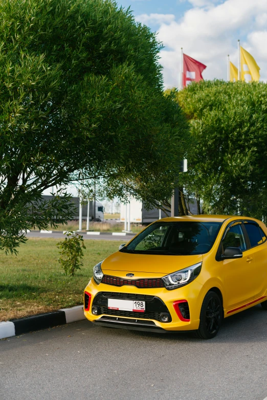 the yellow car has parked behind a pole