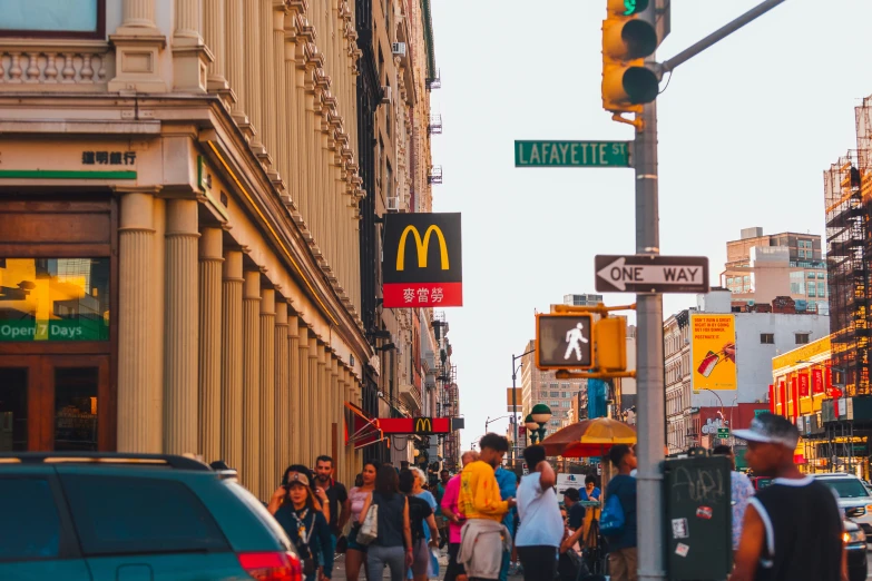 a busy city street lined with people and signs