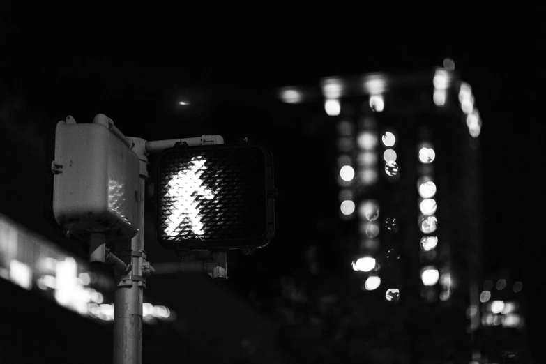 a walk sign in the dark at night time