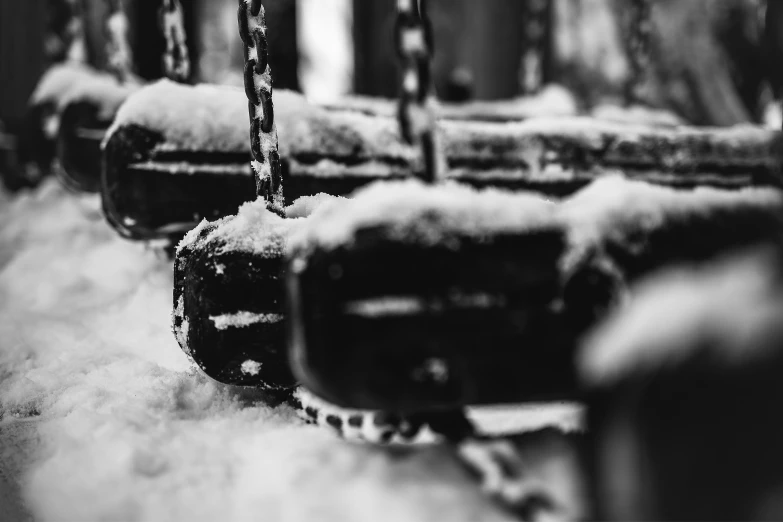 snow is on the ground next to some wooden benches