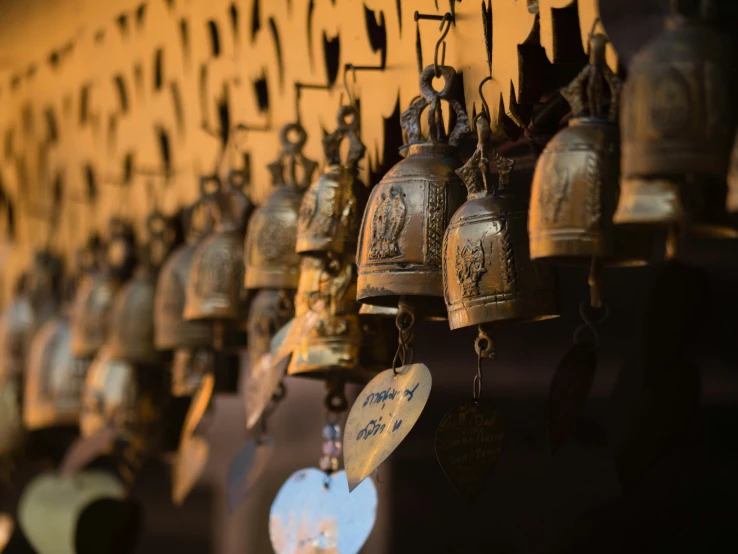 many bell with symbols hang together on the wall