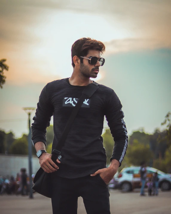 a man in black shirt holding a skateboard