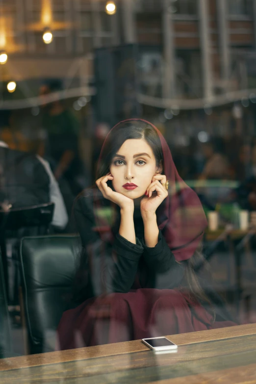 woman looking at soing in the glass window