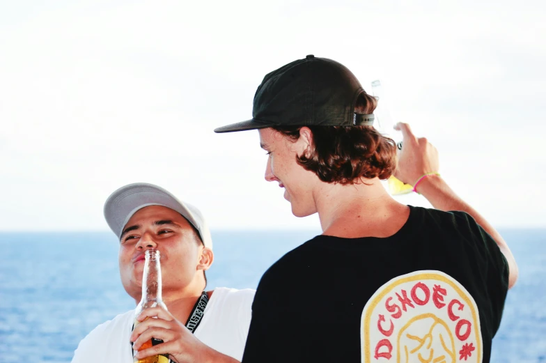 two boys drinking from beverages on a boat