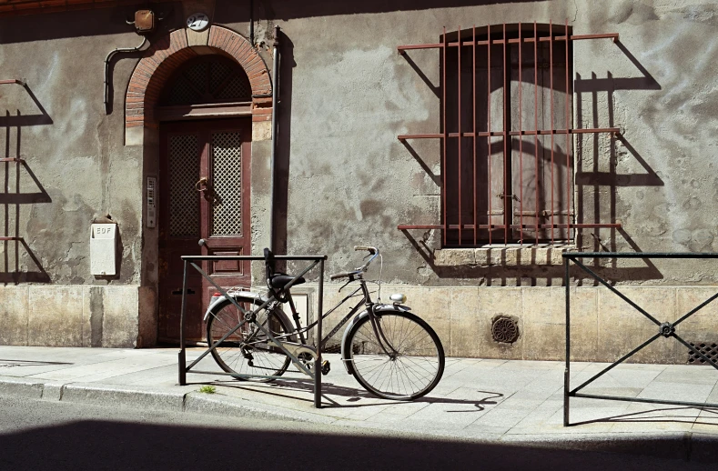 a bicycle is  to the front of a building