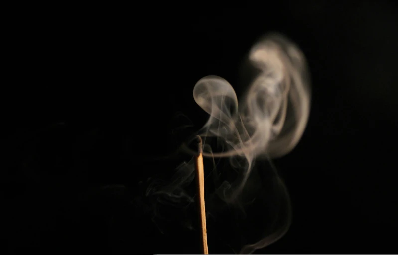 a toothpick that is covered in smoke
