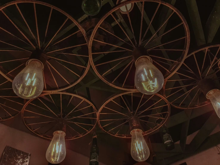 five small lights in an old - fashion style with wooden spoke wheels and glass bulbs