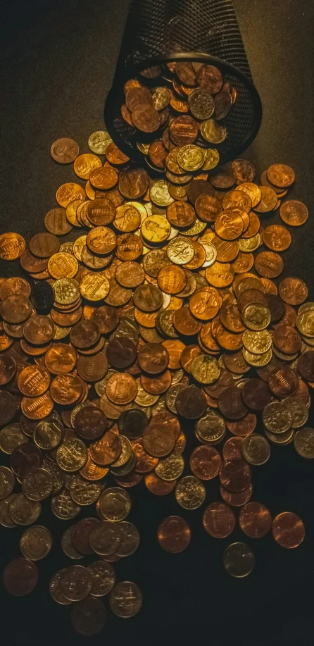 a bag of coins is sitting next to a pile