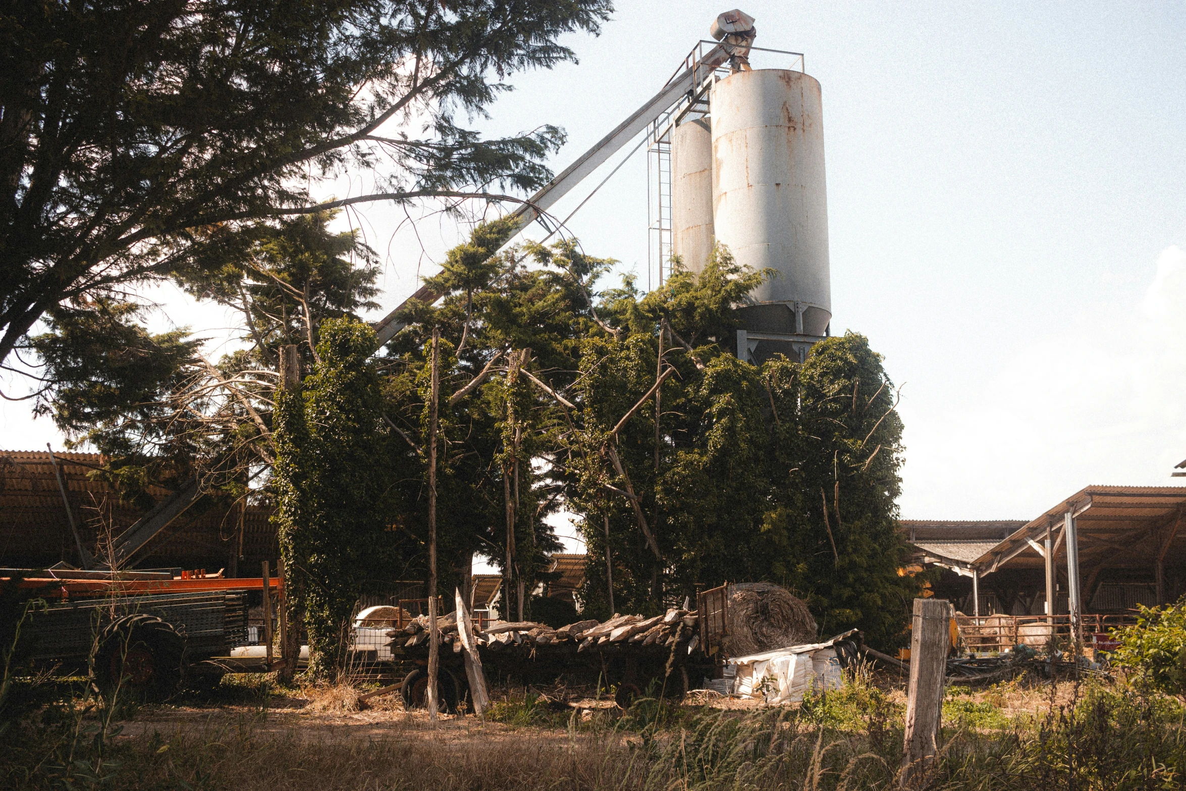 a white silo is outside in the day