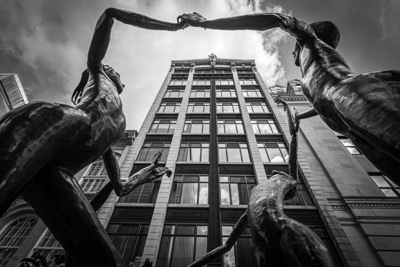 a sculpture of two horses is shown near an office building