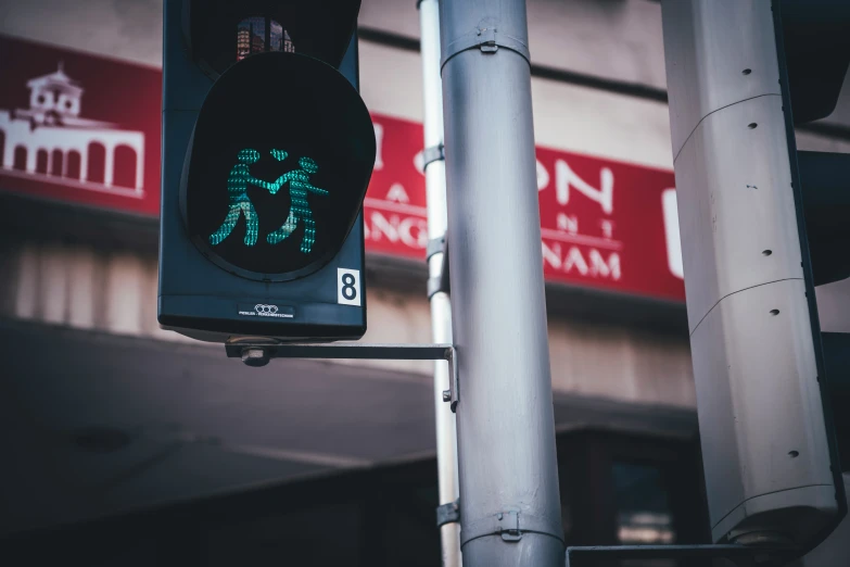 a pedestrian light sits on a pole outside