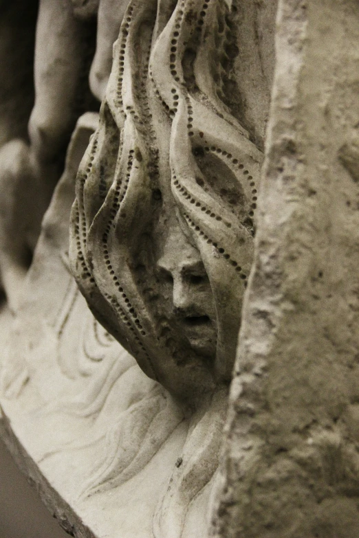 a statue of a woman's head is shown close to the surface