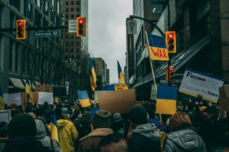 a protest in the city with people holding signs