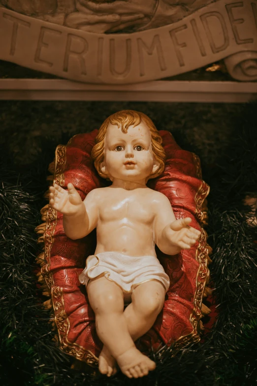 there is a baby statue laying in a chair
