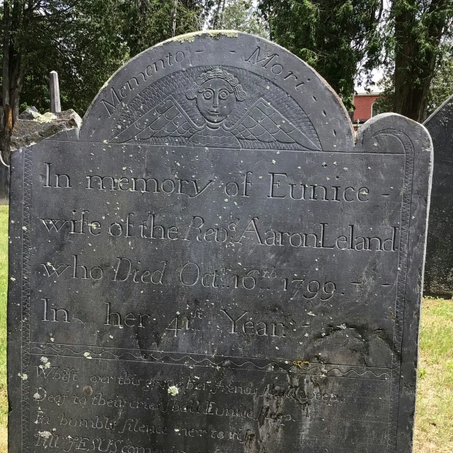 an old tombstone that has a tree and the words i'm in front