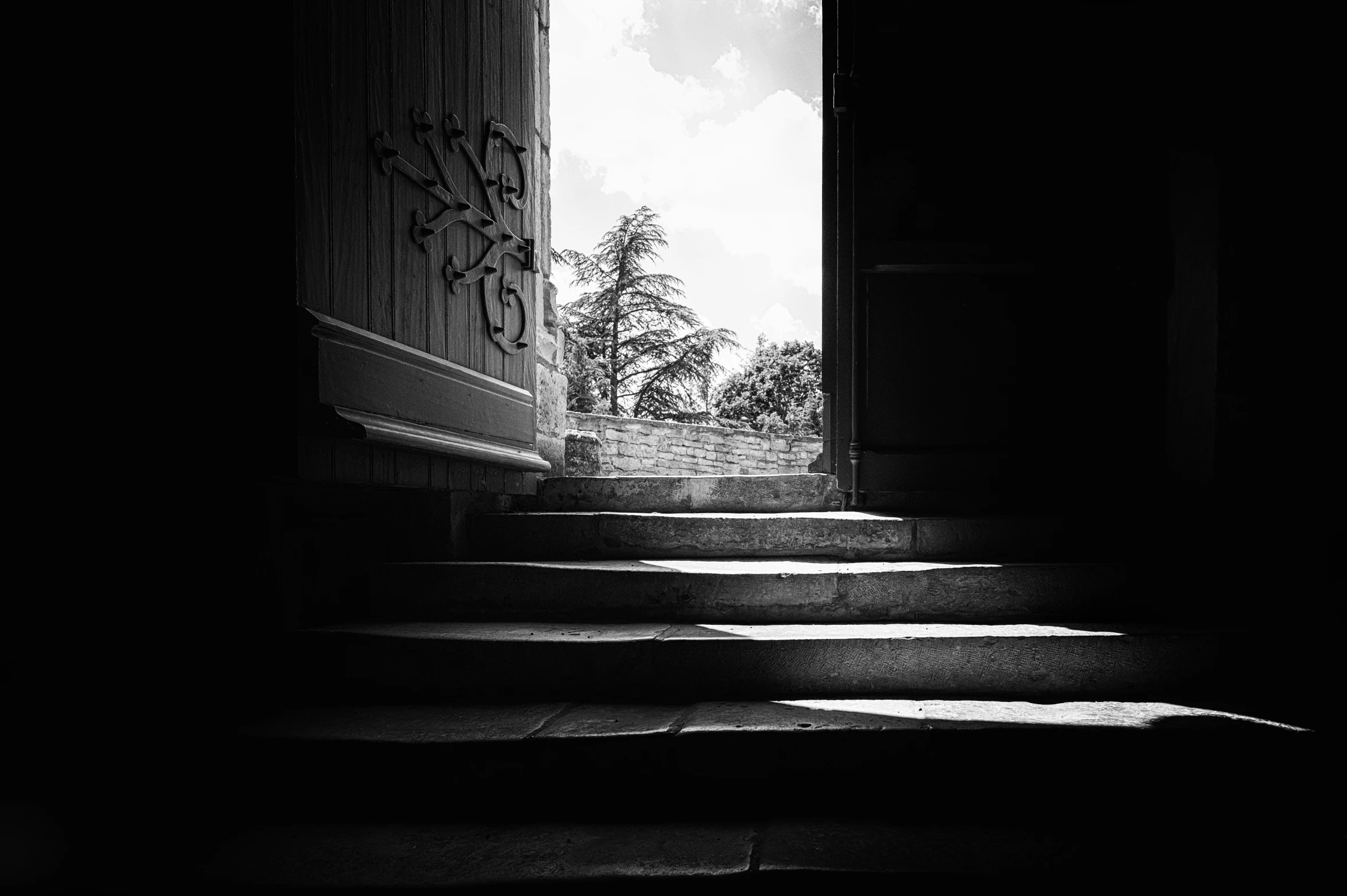 a dark staircase with graffiti on the wall