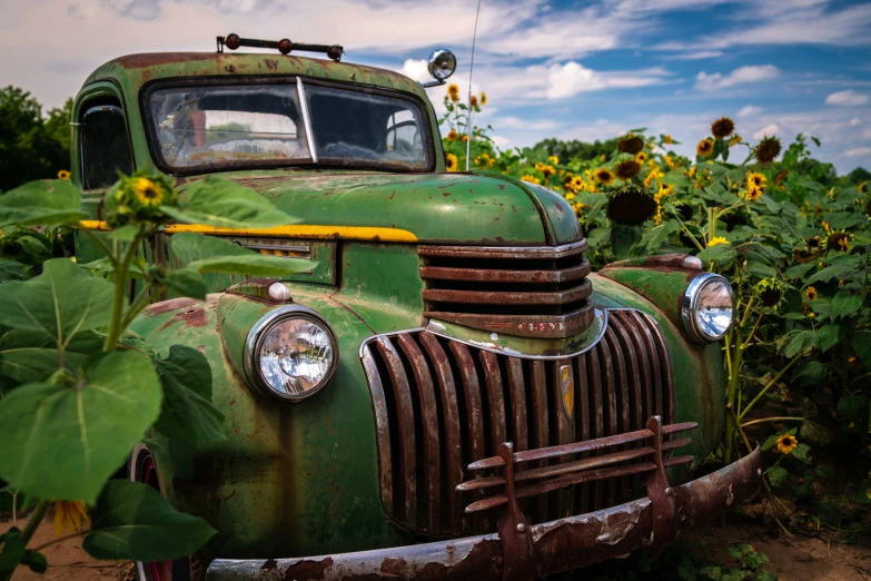 an old truck in the middle of a field