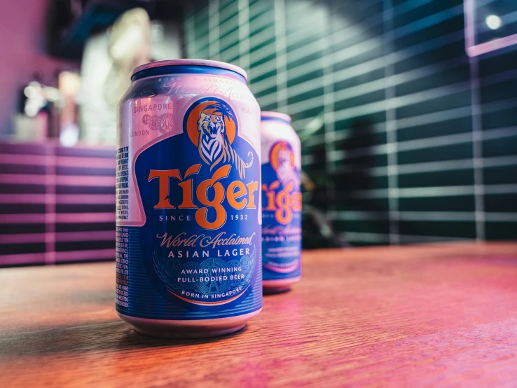 two beer cans sitting on top of a table