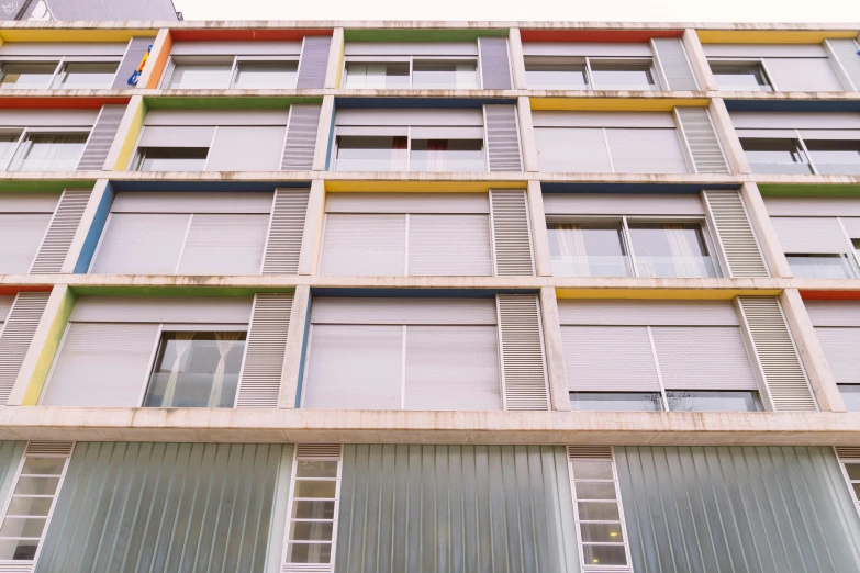 the colorful facade of a multicolored building with several windows