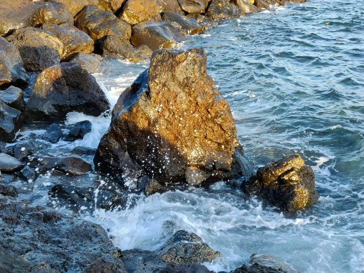 a man stands on the edge of the rocks